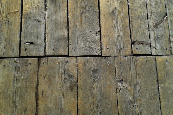 Faded and uneven wood floorboards