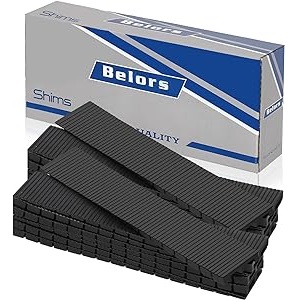 Black plastic Belors shims beside packaging