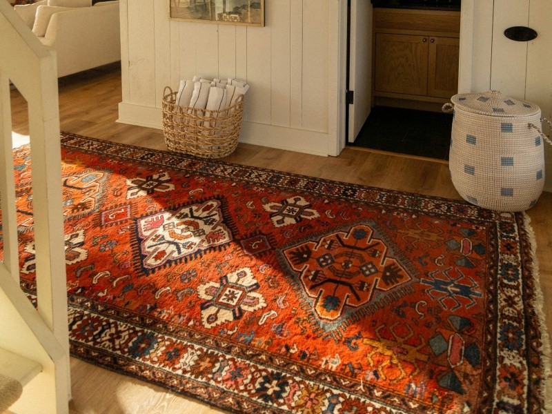 oriental-rug-hallway Oriental rug on wooden floor at the bottom of stairway